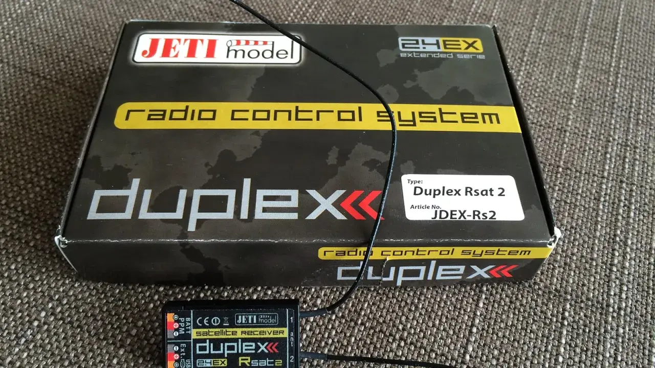Jeti Duplex Rsat 2 Satellitenempfänger und die Verpackung des Jeti Duplex 2.4EX Funksystems.