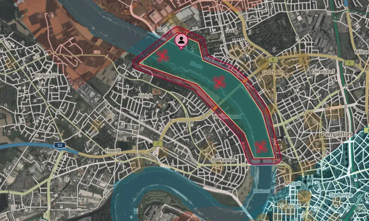 Luftraumüberwachung durch droniq gmbh: Drohnenflugverbotszone über dem Rhein bei Düsseldorf, markiert mit roten Kreuzen.